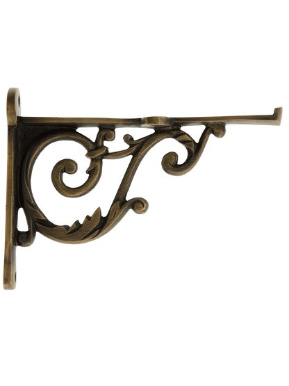 Small Cast Brass Scroll Shelf Bracket In Antique Brass.